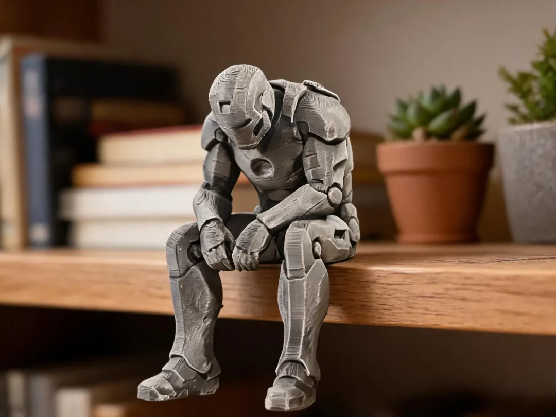 A grey armoured figure sitting on the edge of a wooden shelf beside a plant